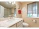 Well-lit bathroom with a granite countertop vanity and ornate mirror at 9402 N 109Th Dr, Sun City, AZ 85351