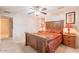 Cozy bedroom with a ceiling fan, side tables and art at 9402 N 109Th Dr, Sun City, AZ 85351