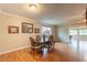 Traditional dining room with wood floors, a table for four, and ample natural light at 9402 N 109Th Dr, Sun City, AZ 85351