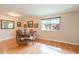 Classic dining room featuring wood floors, a window, and elegant decor at 9402 N 109Th Dr, Sun City, AZ 85351