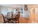 Cozy dining area with wood floors and a view of the living space at 9402 N 109Th Dr, Sun City, AZ 85351