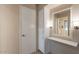 Hallway with built-in shelving and a view into the bathroom at 9402 N 109Th Dr, Sun City, AZ 85351