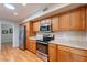 The kitchen features stainless steel appliances, wood cabinets, and stone-look countertops at 9402 N 109Th Dr, Sun City, AZ 85351