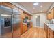 Bright kitchen featuring stainless steel appliances, wood cabinetry, and a skylight at 9402 N 109Th Dr, Sun City, AZ 85351