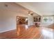 Bright living room with hardwood floors, ceiling fan, and natural light at 9402 N 109Th Dr, Sun City, AZ 85351