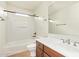 Bright bathroom showcasing a tub with shower, a sleek vanity, and a large mirror at 958 S Henry Ln, Gilbert, AZ 85296