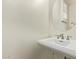 Powder room features white pedestal sink, oval mirror, and shuttered window at 958 S Henry Ln, Gilbert, AZ 85296