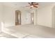 Bedroom with neutral walls, carpet, ceiling fan and arched entryways at 958 S Henry Ln, Gilbert, AZ 85296