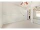 Bedroom featuring plush carpet, ceiling fan and mirrored closet doors at 958 S Henry Ln, Gilbert, AZ 85296