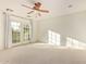 Bright bedroom with ceiling fan, plush carpet and French doors to balcony at 958 S Henry Ln, Gilbert, AZ 85296