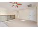 Bright bonus room with carpet, fan, hallway access and decorative railing at 958 S Henry Ln, Gilbert, AZ 85296