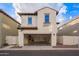 Two-story home boasting a tiled roof, an attached garage, and charming architectural details at 958 S Henry Ln, Gilbert, AZ 85296