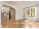 Spacious living room featuring tile floors, a staircase, and a large window at 958 S Henry Ln, Gilbert, AZ 85296