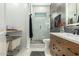 Well-lit bathroom features a glass enclosed shower and wood vanity at 9781 E Gamble Ln, Scottsdale, AZ 85262