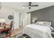 Bedroom with ceiling fan, desk, and en-suite bathroom access at 9781 E Gamble Ln, Scottsdale, AZ 85262