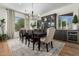 Dining room with rug, dark wooden table, modern light fixture and wine fridge at 9781 E Gamble Ln, Scottsdale, AZ 85262