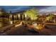 Gorgeous desert landscaping and night lighting lead up to a two car garage and southwestern home at 9781 E Gamble Ln, Scottsdale, AZ 85262