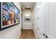 Hallway featuring neutral colored walls, wood floors, and stylish modern artwork at 9781 E Gamble Ln, Scottsdale, AZ 85262