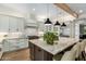 Spacious kitchen with island, seating, stainless steel appliances and wooden beam at 9781 E Gamble Ln, Scottsdale, AZ 85262