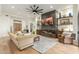 Stylish living room with modern fireplace and a large ceiling fan at 9781 E Gamble Ln, Scottsdale, AZ 85262