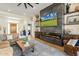 Elegant living room featuring a large, modern fireplace and hardwood floors at 9781 E Gamble Ln, Scottsdale, AZ 85262