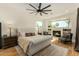 Bright main bedroom featuring a fireplace, ceiling fan and decorative furnishings at 9781 E Gamble Ln, Scottsdale, AZ 85262