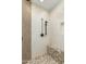 A modern tiled shower with rain shower head, bench and accent wall at 9781 E Gamble Ln, Scottsdale, AZ 85262