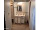 Bathroom with vanity, white cabinets, gold framed mirror and white-tiled countertop at 981 N Sherwood Way, Queen Valley, AZ 85118