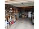 Spacious garage with concrete floor and block walls with storage shelves at 981 N Sherwood Way, Queen Valley, AZ 85118