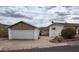 Exterior shot of detached garage with white door and paint, next to a house at 981 N Sherwood Way, Queen Valley, AZ 85118