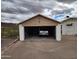 View of the open garage exterior featuring a vehicle in the rear at 981 N Sherwood Way, Queen Valley, AZ 85118