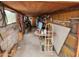 Interior of garage showing workshop space with table and hand truck at 981 N Sherwood Way, Queen Valley, AZ 85118