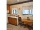 Traditional kitchen with wood cabinets, a drop-leaf table, and tile flooring at 981 N Sherwood Way, Queen Valley, AZ 85118