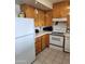 Functional kitchen with white appliances, wood cabinets, and ample counter space at 981 N Sherwood Way, Queen Valley, AZ 85118