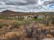 Rolling desert landscape with scattered homes and stunning mountain views under a partly cloudy sky, Arizona landscape at 981 N Sherwood Way, Queen Valley, AZ 85118