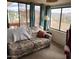 Comfortable living area with a patterned sofa and large windows showcasing a scenic view at 981 N Sherwood Way, Queen Valley, AZ 85118