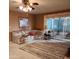 Cozy living room with floral sofa, carpeted floor and a glass sliding door to outdoor space at 981 N Sherwood Way, Queen Valley, AZ 85118