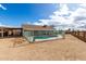 The backyard features a fenced pool and a covered patio with a gravel perimeter at 10216 W Minnezona Ave, Phoenix, AZ 85037