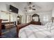 Bright bedroom featuring a ceiling fan, closet with mirrored doors, and a luxurious sleigh bed at 10216 W Minnezona Ave, Phoenix, AZ 85037