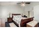 Comfortable bedroom featuring a sleigh bed, a nightstand with a lamp, and soft carpeting at 10216 W Minnezona Ave, Phoenix, AZ 85037