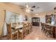 Spacious dining room with vaulted ceilings, a long table, and seating for eight at 10216 W Minnezona Ave, Phoenix, AZ 85037