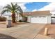 Single-story home with a two-car garage and desert landscaping at 10216 W Minnezona Ave, Phoenix, AZ 85037