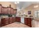 Open kitchen design featuring a breakfast bar, wood cabinets, and modern appliances at 10216 W Minnezona Ave, Phoenix, AZ 85037