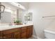 Bathroom showcasing double sinks, decorative lighting, and framed mirrors at 10757 N 74Th St # 2003, Scottsdale, AZ 85260