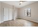 Well-lit bedroom features wood-look floors, large windows, and closet space at 10757 N 74Th St # 2003, Scottsdale, AZ 85260