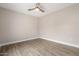 Bedroom with wood-look floors, neutral paint, ceiling fan, and natural light at 10757 N 74Th St # 2003, Scottsdale, AZ 85260