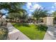 Well-maintained community lawn with lush green grass, mature trees, and gated pool access at 10757 N 74Th St # 2003, Scottsdale, AZ 85260