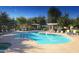 Resort-style community pool with lounge chairs, grilling area, and shaded seating at 10757 N 74Th St # 2003, Scottsdale, AZ 85260