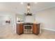 Kitchen island features stainless steel oven, electric cooktop, granite counters and breakfast bar at 10757 N 74Th St # 2003, Scottsdale, AZ 85260