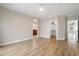 Bright living room with wood-look floors, neutral walls, arched entryway, and ample natural light at 10757 N 74Th St # 2003, Scottsdale, AZ 85260